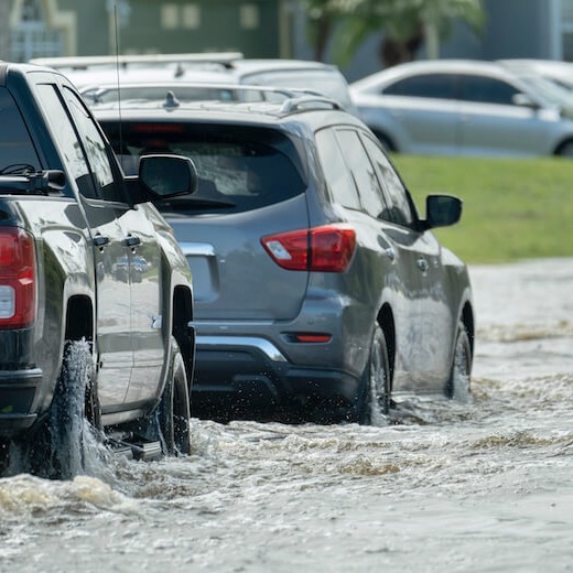 Cars Drive Through Flood Areas
