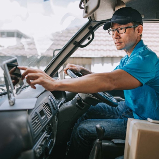 man planning truck route on GPS